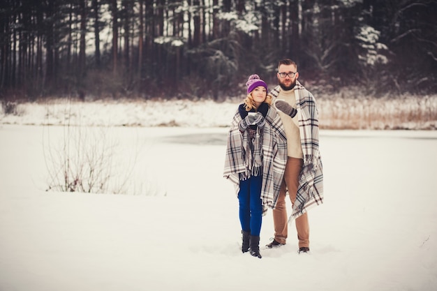 Happy young couple in winter forest