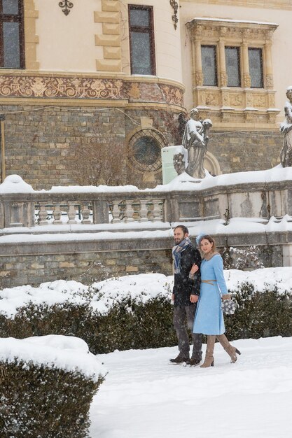 Happy Young Couple in Winter Park Family outdoors at the castle