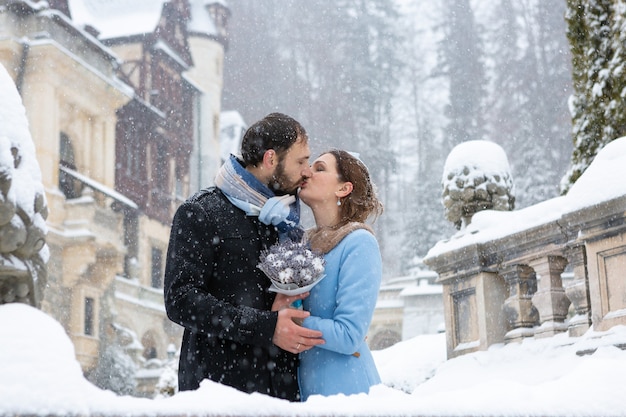 Happy Young Couple in Winter Park. Family outdoors at the castle.