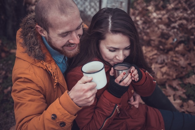 Happy Young Couple in Winter Park having fun. Family Outdoors.