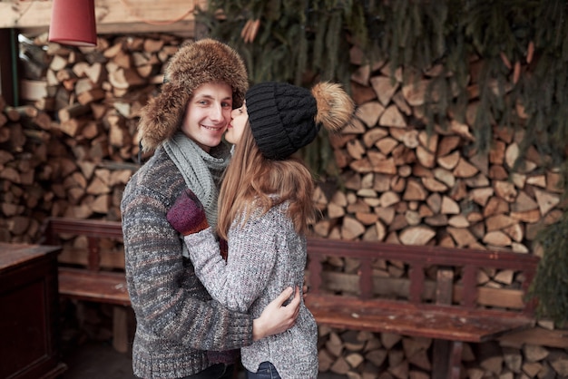 Happy Young Couple in Winter Park having fun.Family Outdoors.