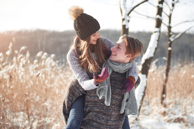 Happy Young Couple in Winter Park having fun.Family Outdoors