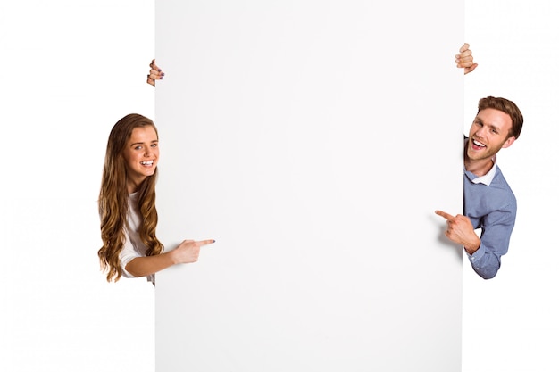 Happy young couple with blank board