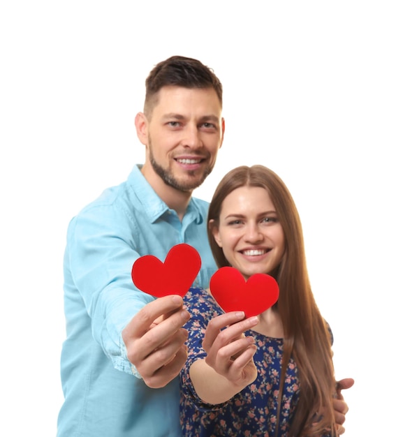 Happy young couple with red hearts on white background