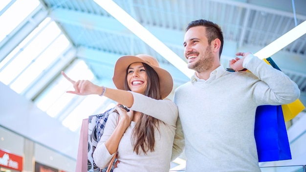 Happy young couple with shopping bags