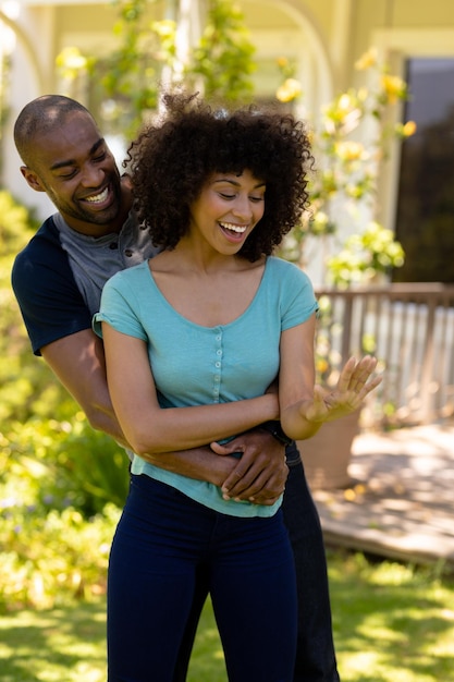 Happy young couple with woman looking her ring