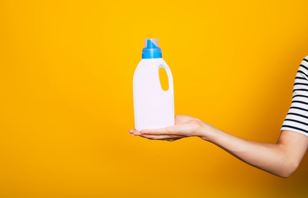 Happy young cute girl in casual wear is posing with some equipment and supply for house cleaning