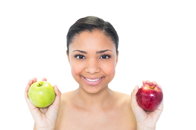 Happy young dark haired model holding apples