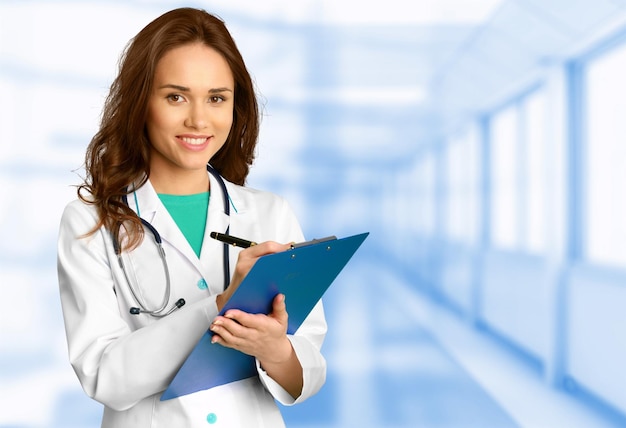 Happy young doctor with clipboard