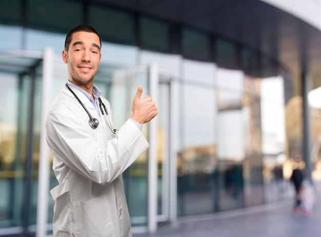 Happy young doctor with an okay gesture