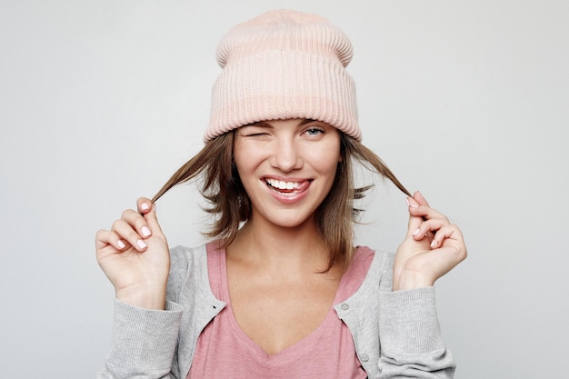 Happy young emotional woman wearing pink hat