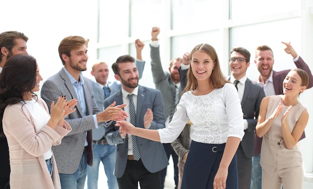 Happy young employees greeting their young colleague