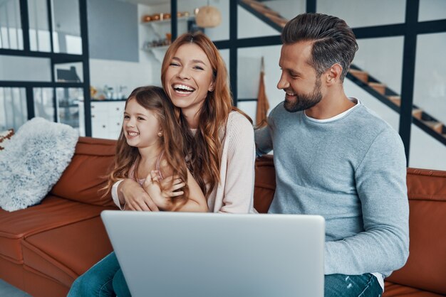 Happy young family bonding together at home