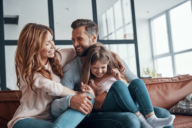 Happy young family bonding together at home