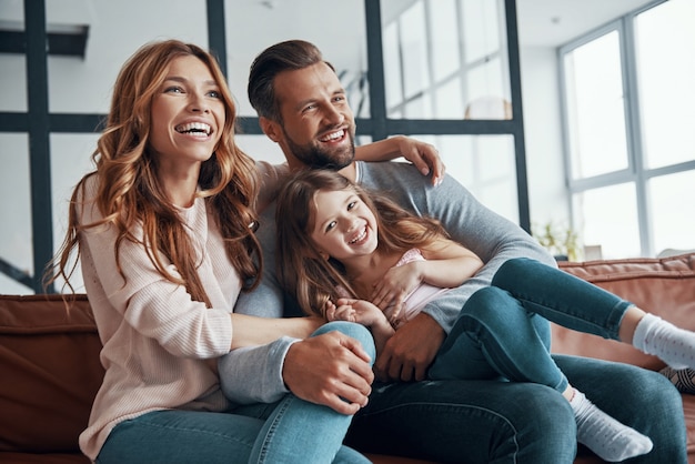 Happy young family bonding together at home