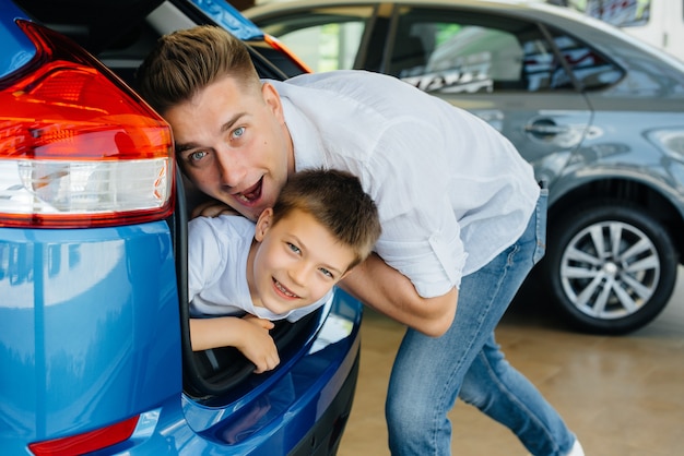 A happy young family at the car dealership