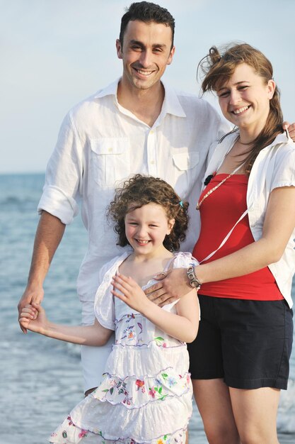 happy young family have fun and live healthy lifestyle on beach