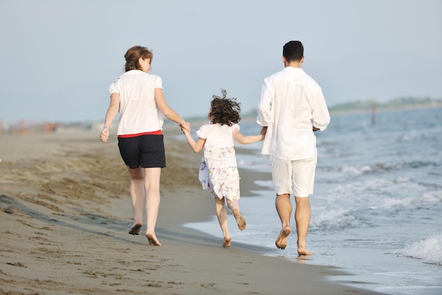 happy young family have fun and live healthy lifestyle on beach