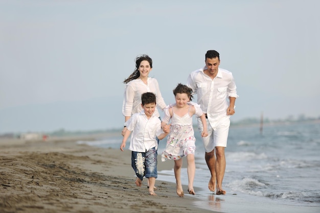 happy young family have fun and live healthy lifestyle on beach