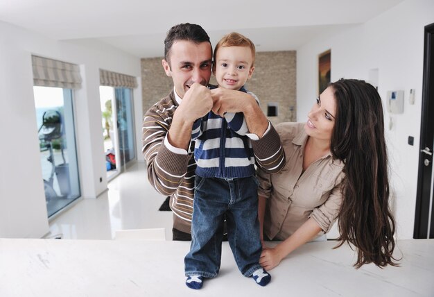 happy young family have fun and relaxing at new home with bright furniture