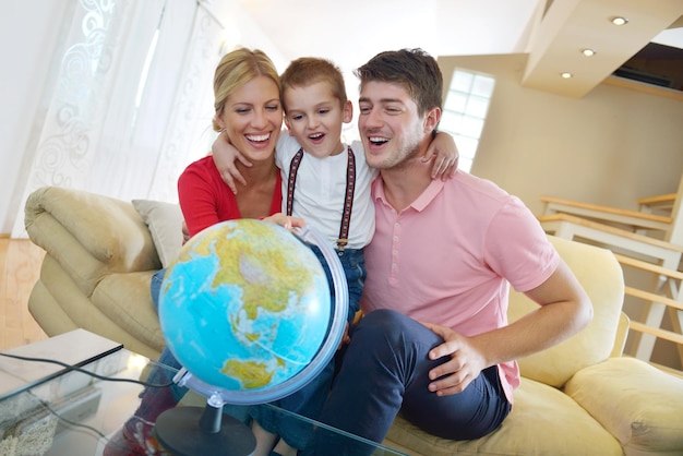 happy young family have fun with globe