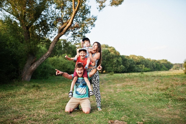 Happy young family mother father two children son on nature having fun