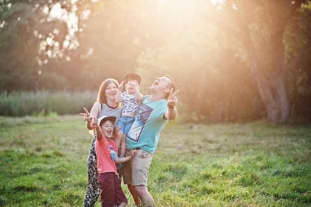 Happy young family mother father two children son on nature having fun