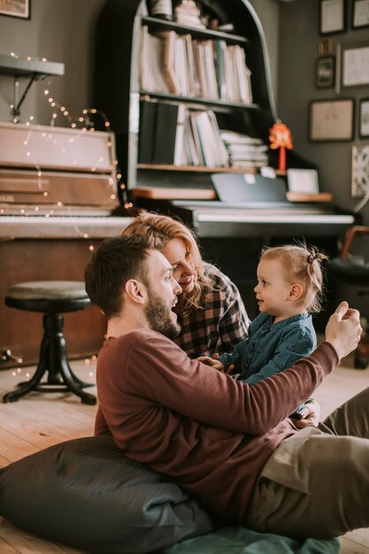 Happy young family playing on the floor  in the room