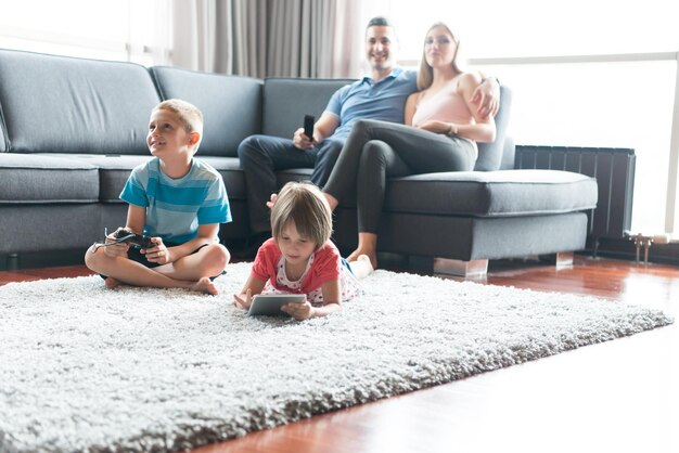 Photo happy young family playing together at home