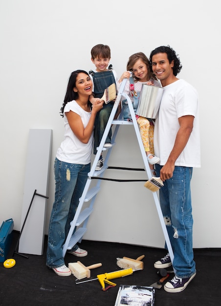 Happy young family renovating a room 