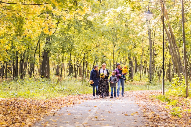 Happy young family spending time together outside in autumn nature