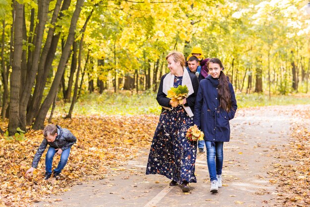 Happy young family spending time together outside in autumn nature