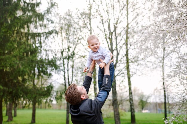 Happy young family walking in a city park