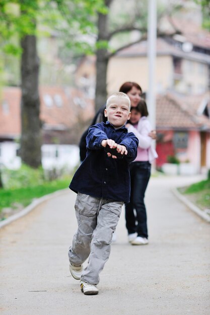 happy young family walking outdoor in park