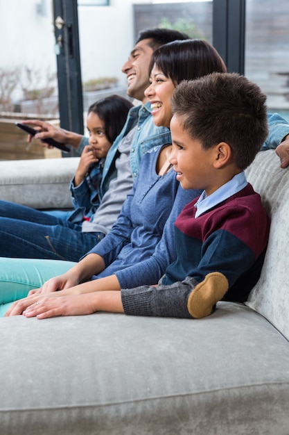 Happy young family watching tv