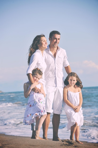 happy young family in white clothing have fun at vacations on beautiful beach