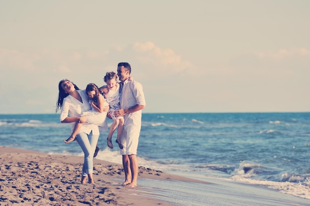 happy young family in white clothing have fun at vacations on beautiful beach