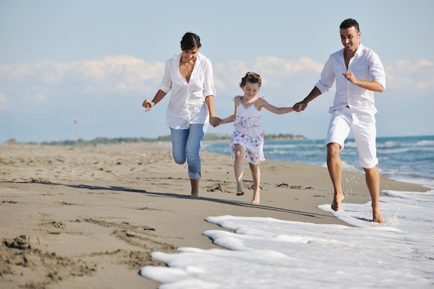 happy young family in white clothing have fun at vacations on beautiful beach