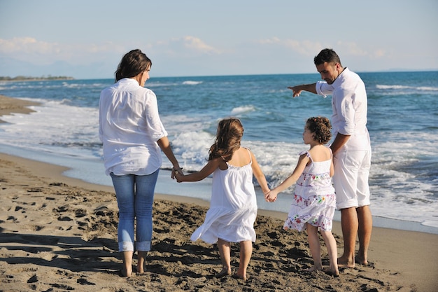 happy young family in white clothing have fun at vacations on beautiful beach