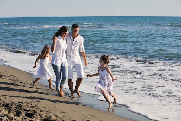 happy young family in white clothing have fun at vacations on beautiful beach