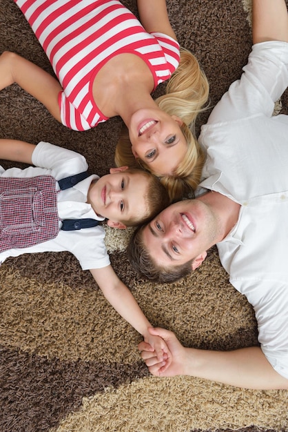 happy young family with kids in bright modern living room have fun and looking big flat lcd tv