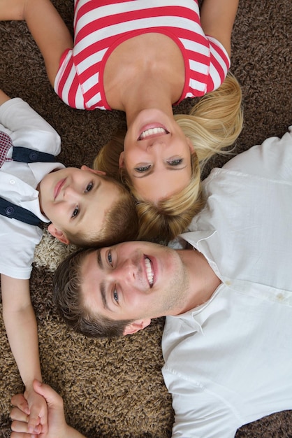 happy young family with kids in bright modern living room have fun and looking big flat lcd tv