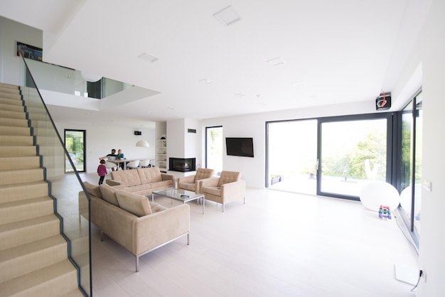 happy young family with little girl enjoys in the modern living room of their luxury home villa