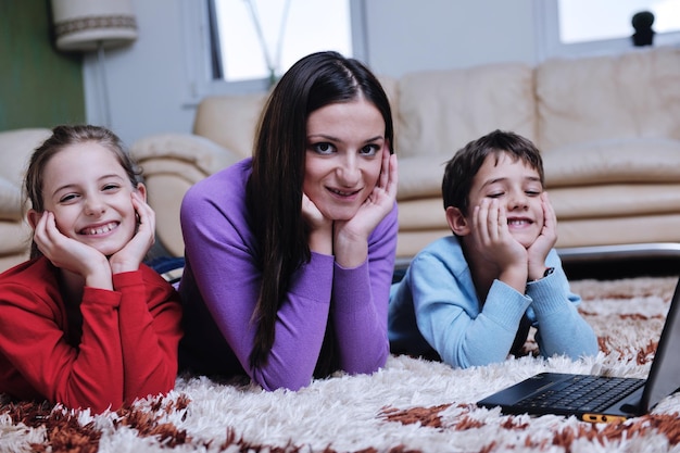 happy young family with mom and kids have fun and play in modern new living room home indoor