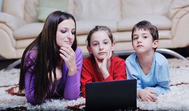 happy young family with mom and kids have fun and play in modern new living room home indoor