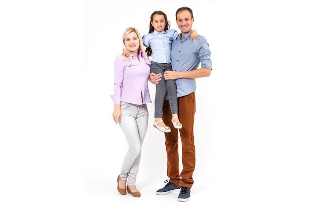 Happy young family with pretty child posing on white background