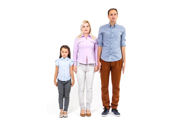 Happy young family with pretty child posing on white background