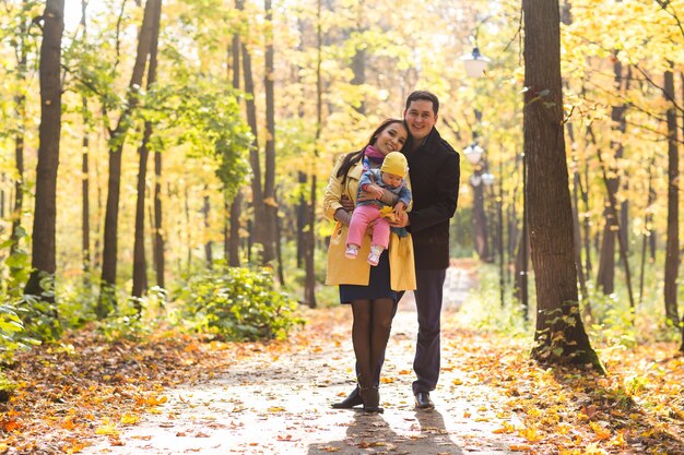 happy young family with their daughter spending time outdoor in the park