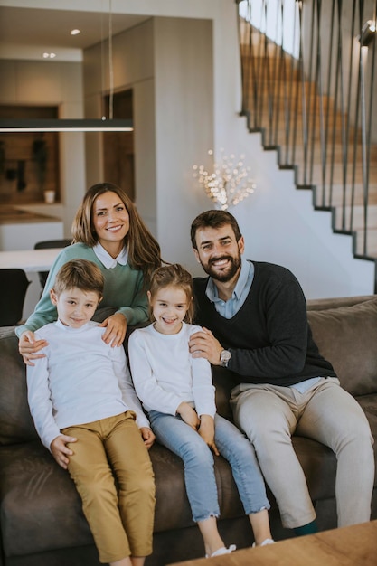 Photo happy young family with two kids enjoy time together on couch in living room