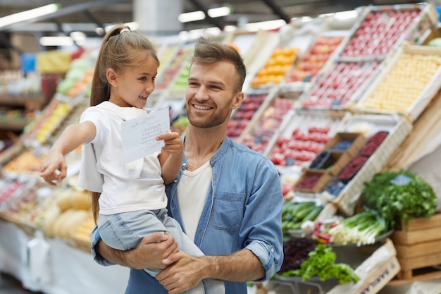 Happy Young Father in Supermarket